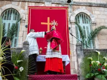Cardinal Pierbattista Pizzaballa, the Latin Patriarch of Jerusalem, gives the final blessing with the relic of the holy cross at the end of the Palm Sunday procession from Bethphage to Jerusalem on March 24, 2024.