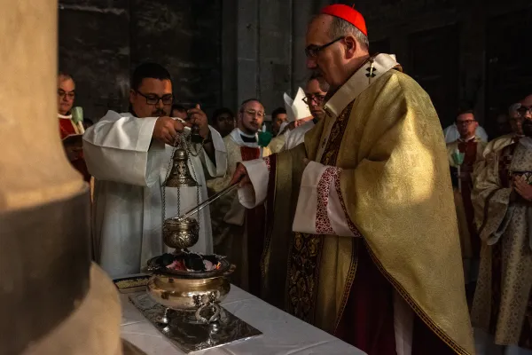 Cardinal Pierbattista Pizzaballa, the Latin patriarch of Jerusalem, places the embers of the newly blessed fire inside the incense burner, during the Easter Vigil, on the morning of Saturday, March 30, 2024. Credit: Marinella Bandini