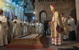 With the incense burned from the newly blessed fire, Cardinal Pierbattista Pizzaballa, the Latin patriarch of Jerusalem, incenses the "Stone of Anointing," located at the entrance of the Basilica of the Holy Sepulcher, where, according to tradition, the body of Jesus was anointed and prepared with aromatic oils for burial. March 30, 2024. Credit: Marinella Bandini