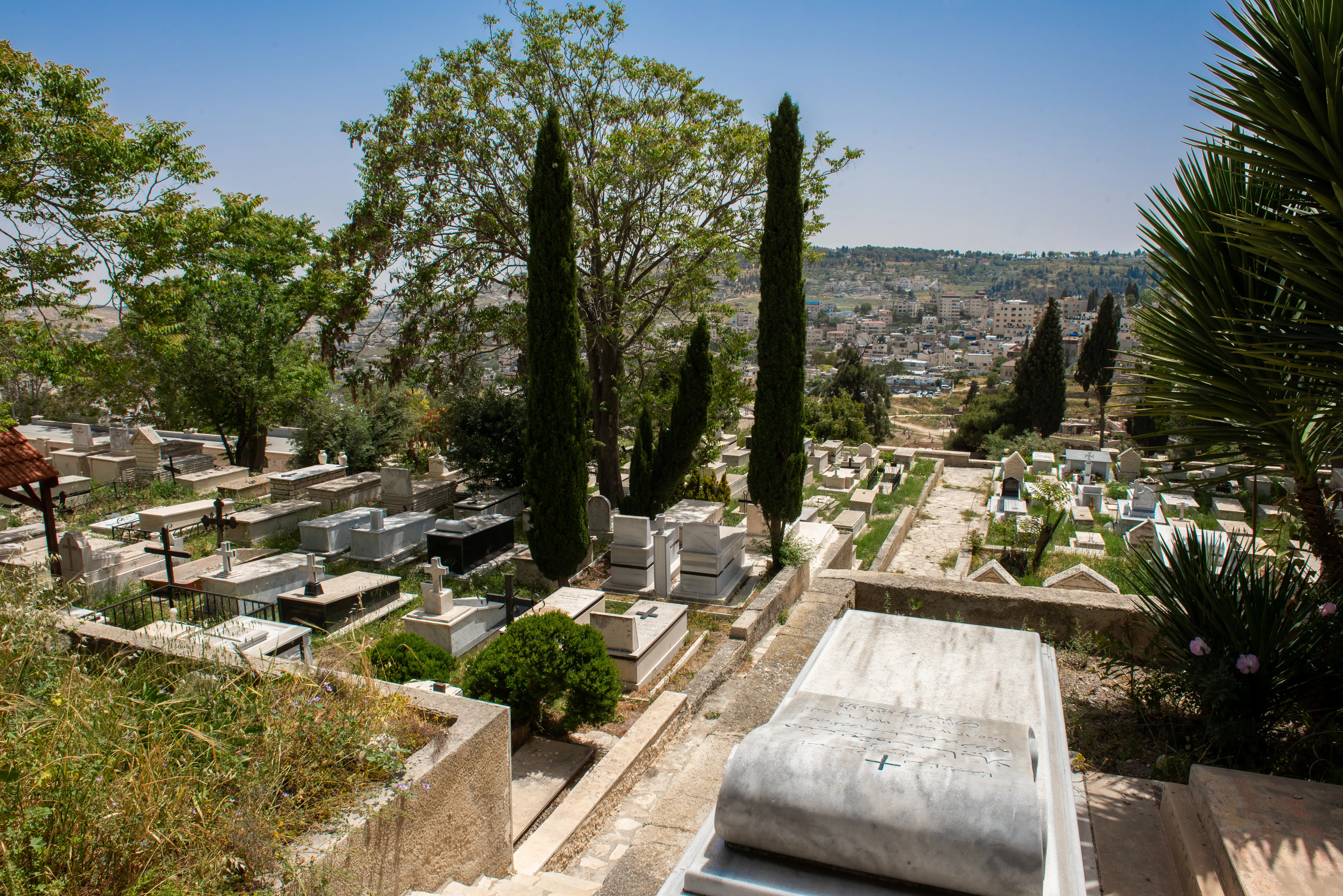 A view of the modern area of the Catholic cemetery located on the southern hillside of Mount Zion in April 2024. In the background are the buildings of the Arabic neighborhood of Abu Tor.?w=200&h=150