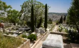 A view of the modern area of the Catholic cemetery located on the southern hillside of Mount Zion in April 2024. In the background are the buildings of the Arabic neighborhood of Abu Tor.