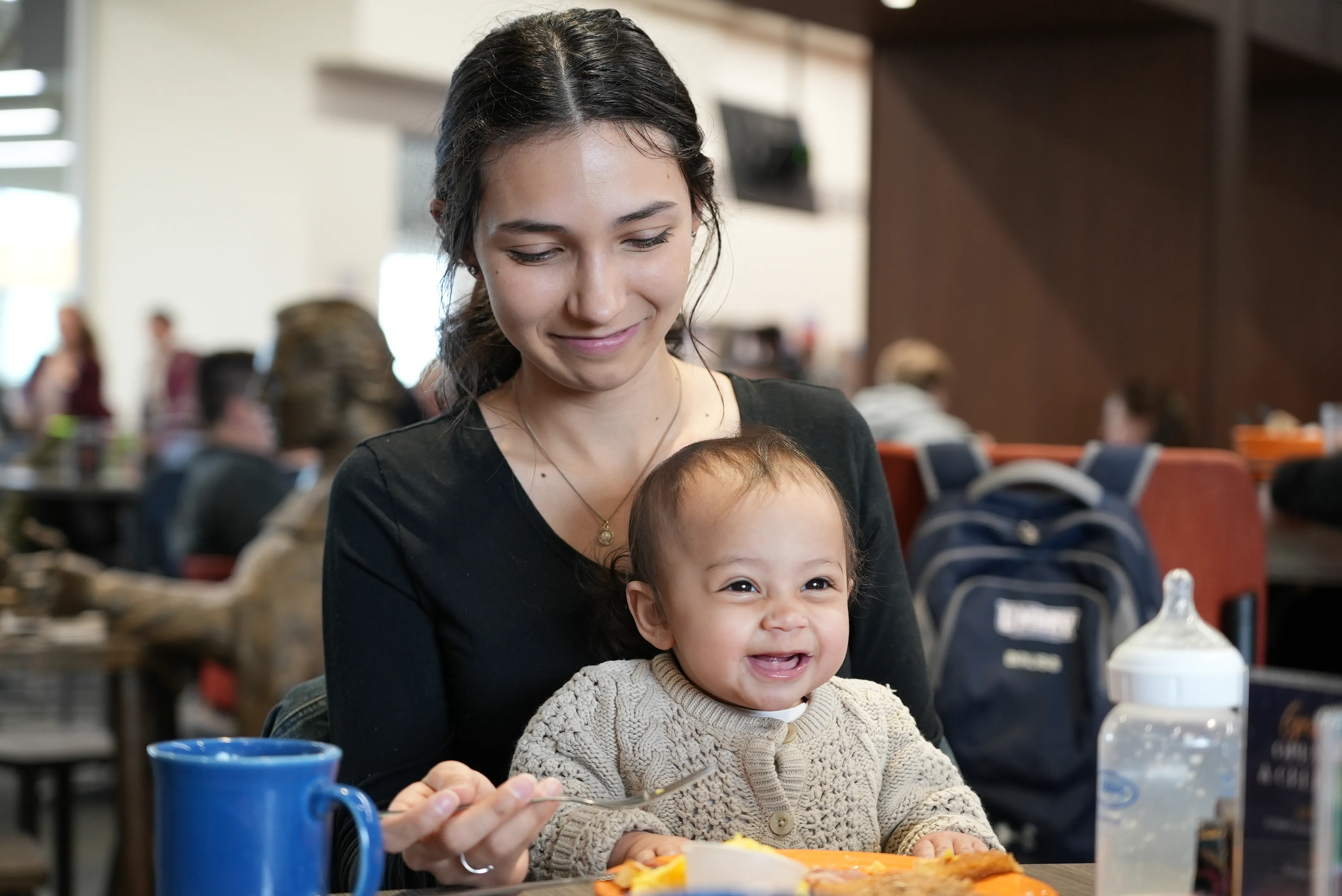 Katie Chihoski, a student at the University of Mary in Bismarck, North Dakota, eats with her baby, Lucia, on her lap in the company of fellow students. Chihoski is among the first students to benefit from a new initiative at the Catholic college called the Saint Teresa of Calcutta Community for Mothers, which provides free babysitting and other material support for young mothers on campus.?w=200&h=150