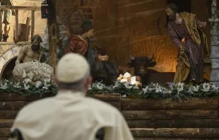 Pope Francis prays in front of the nativity scene after Christmas Mass Dec. 24, 2022. Credit: Vatican Media.