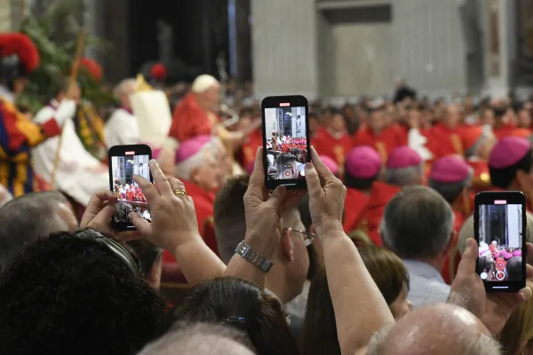 People try to snap a photo of the pope on their phones at the Pentecost Mass in St. Peter’s Basilica on May 28, 2023. Vatican Media