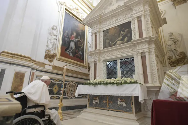 Pope Francis prays at the tomb of Pope Celestine V in L'Aquila, Italy. Vatican Media