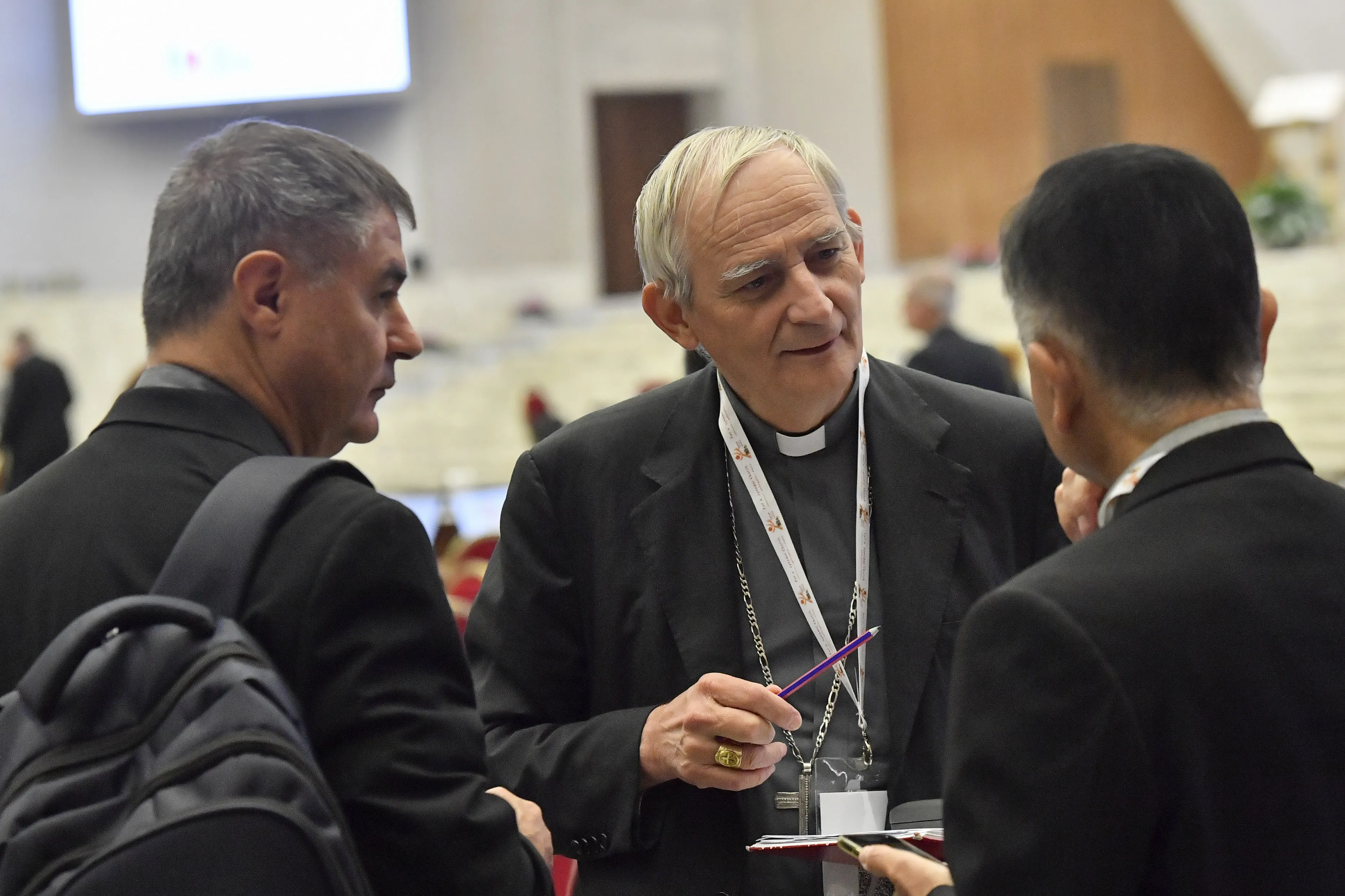 Cardinal Matteo Zuppi talks with other Synod on Synodality delegates at the general congregation assembly Oct. 9, 2023.?w=200&h=150