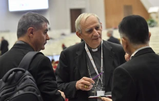 Cardinal Matteo Zuppi talks with other Synod on Synodality delegates at the general congregation assembly Oct. 9, 2023. Credit: Vatican Media