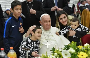 Pope Francis poses with a woman and three children during a lunch in the Vatican's Paul VI Hall for over 1,000 poor and economically disadvantaged people on Nov. 19, 2023. Credit: Vatican Media