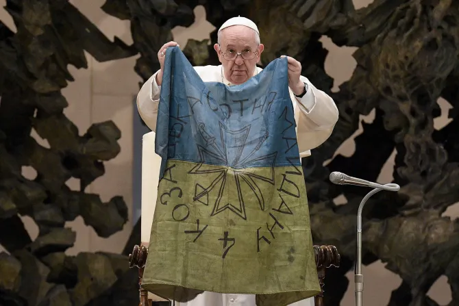 Pope Francis holds a flag that he received from Bucha, Ukraine on April 6, 2022.