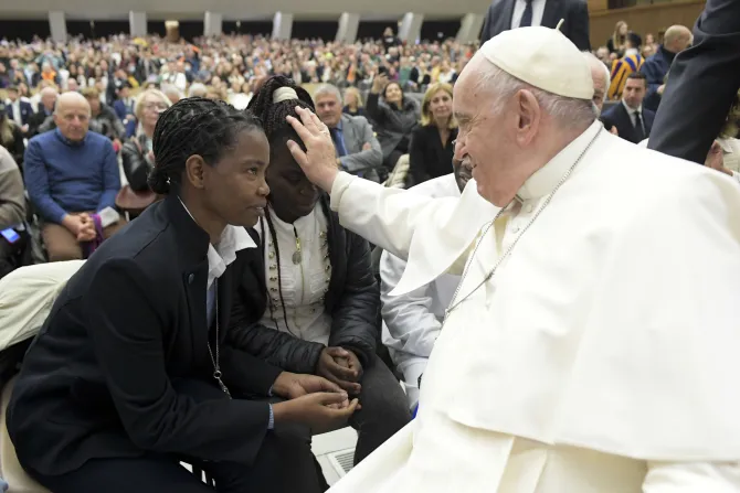 Pope Francis blesses a young woman during a general audience in December 2022.