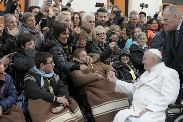 Pope Francis greets a woman in a wheelchair in Rome's Piazza di Spagna on Dec. 8, 2022. Vatican Media