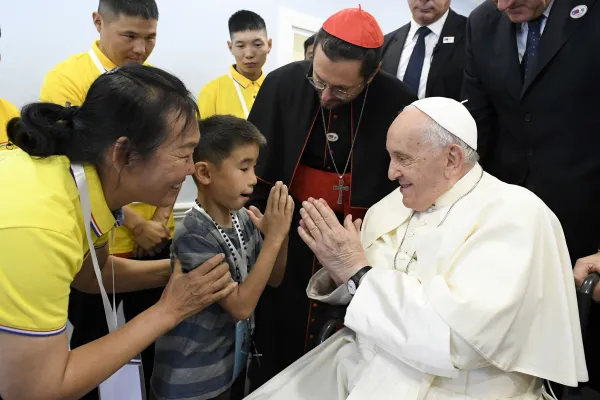 Pope Francis greets a boy during a visit to the House of Mercy, a new charitable effort in Ulaanbaatar, Mongolia, on Sept. 4, 2023. Vatican Media
