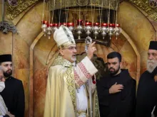 Patriarch Pierbattista Pizzaballa blesses the congregation at the Church of the Holy Sepulchre in Jerusalem on April 4, 2021.