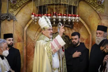 Patriarch Pierbattista Pizzaballa blesses the congregation at the Church of the Holy Sepulchre in Jerusalem on April 4, 2021.