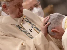 Pope Francis lays his hands on the head of Guido Marini during his episcopal consecration in St. Peter's Basilica Oct. 17, 2021