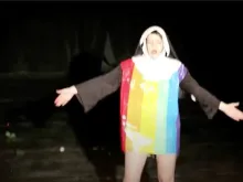 A drag performer dresses up as a Catholic religious sister and dances provocatively on stage while wearing a gay pride flag.