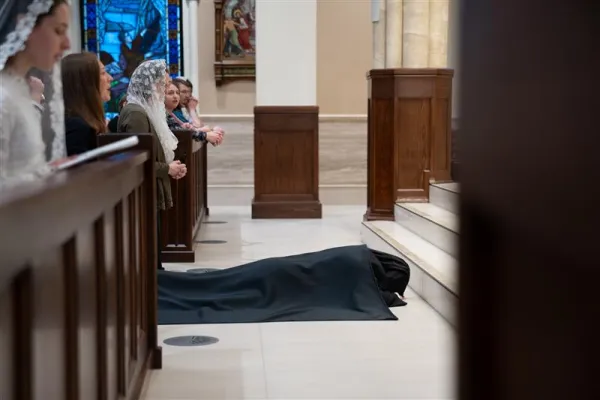 Mother Chiara prostrates before her final vows while the litany of the saints is sung on Jan. 6, 2024. Credit: Deborah Kates Photography