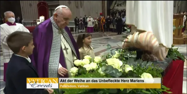 Pope Francis presents flowers to a Marian statue following the act of consecration.