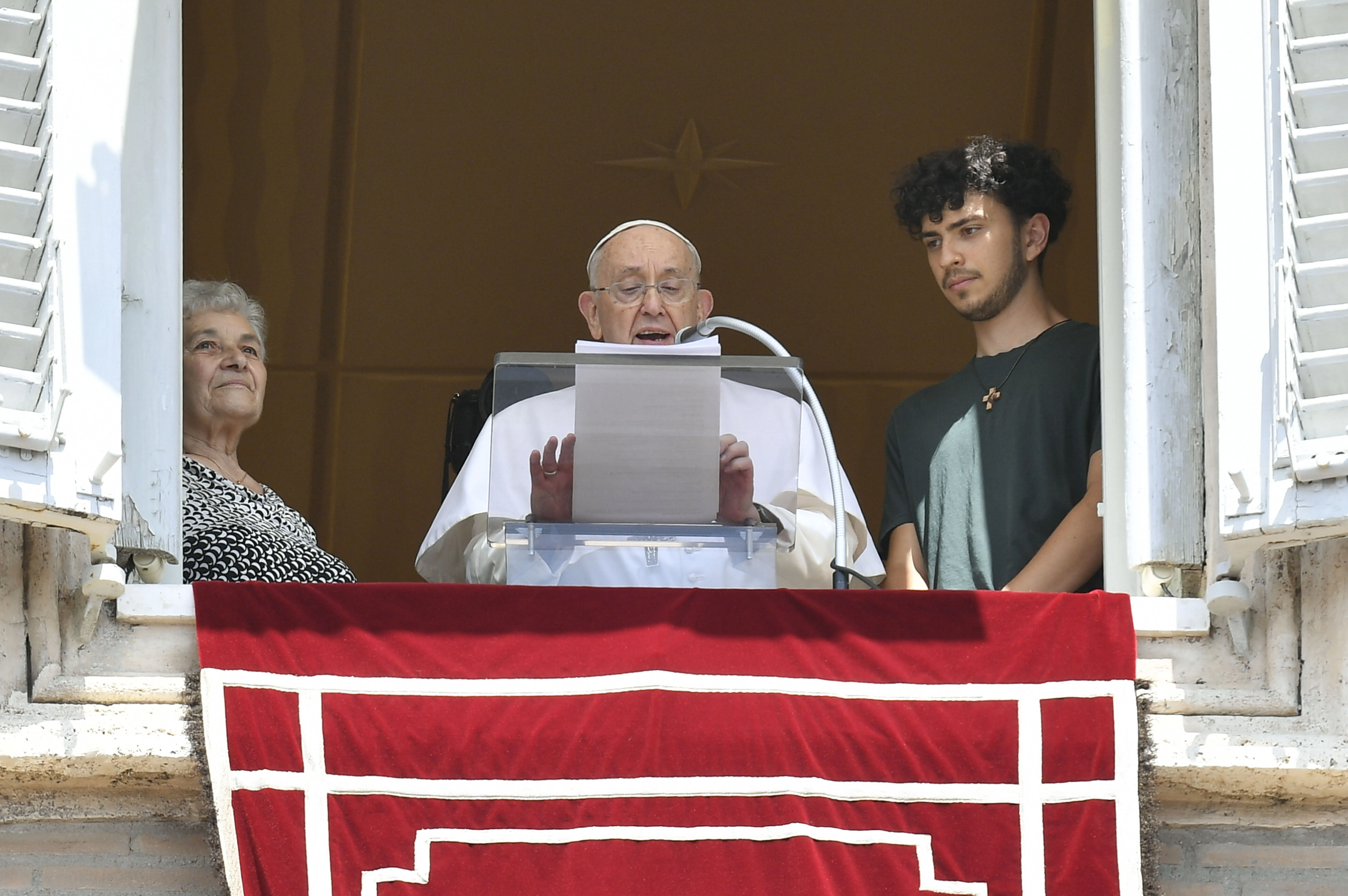 Pope Francis is flanked by a grandmother and grandson during his Angelus reflection on July 23, 2023, in honor of the World Day for Grandparents and the Elderly.?w=200&h=150