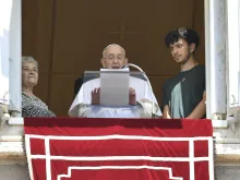 Pope Francis is flanked by a grandmother and grandson during his Angelus reflection on July 23, 2023, in honor of the World Day for Grandparents and the Elderly.