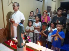 Father Caleb Laldawngsanga leads refugees from violence-torn Manipur in the praying of a rosary.