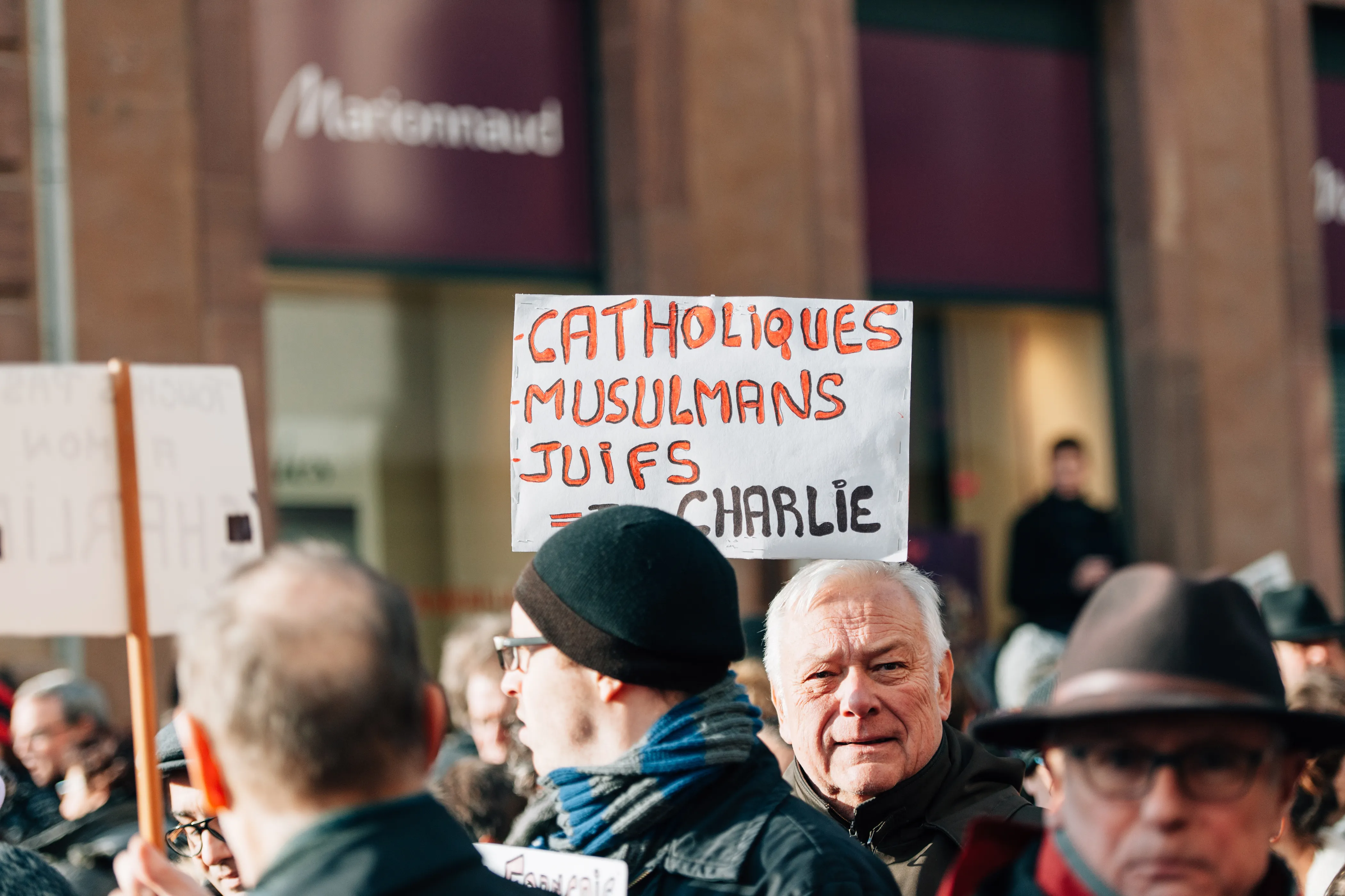 People in Strasbourg, France, hold placards reading "Catholics, muslims, jews all are Charlie" during a unity rally on Jan. 11, 2015 following a mass shooting by Muslim terrorists at the offices of the French satirical weekly newspaper Charlie Hebdo in Paris.?w=200&h=150