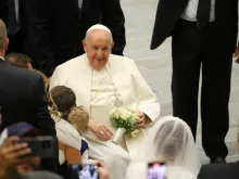 Pope Francis greets newly married couples at the general audience in the Vatican's Paul VI Hall on Aug. 30, 2023.