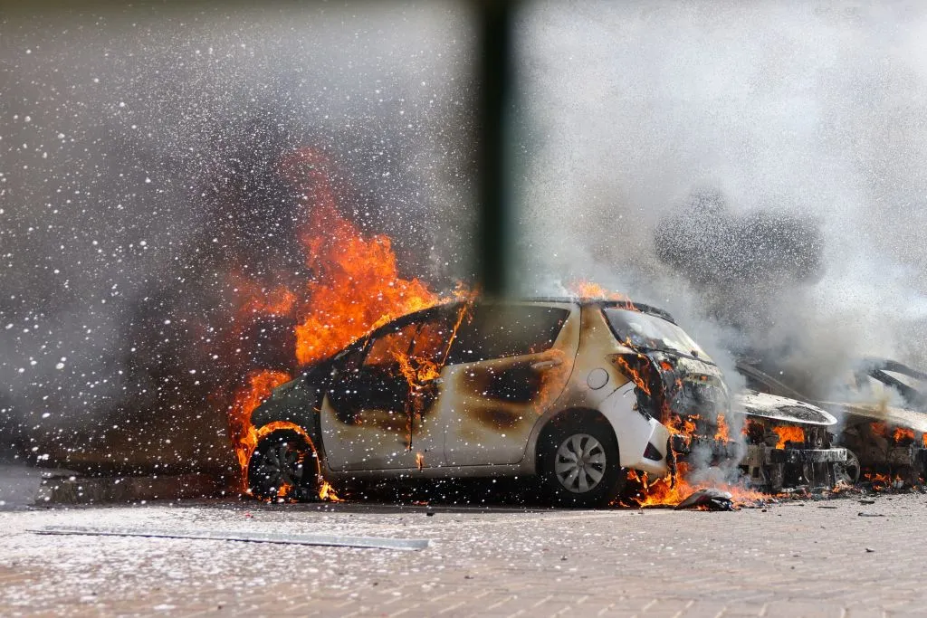 Cars are seen on fire following a rocket attack from the Gaza Strip in Ashkelon, southern Israel, on Oct. 7, 2023.?w=200&h=150