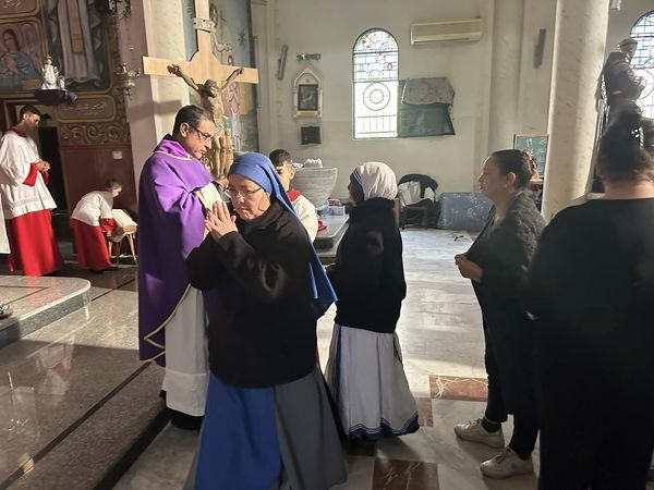 Religious sisters, including a Missionary of Charity, receive Communion at Holy Family Parish in Gaza. Credit: Father Gabriel Romanelli/Facebook