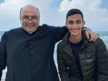 Suhail Shadi Abu Dawod with Father Gabriel Romanelli, the parish priest of Gaza, on the seashore in Gaza last summer 2023. Romanelli, belongs to the Institute of the Incarnate Word (IVE), a Catholic clerical religious institute founded in Argentina on March 25, 1984, which Abu Dawod has petitioned to join.