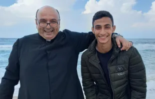 Suhail Shadi Abu Dawod with Father Gabriel Romanelli, the parish priest of Gaza, on the seashore in Gaza last summer 2023. Romanelli, belongs to the Institute of the Incarnate Word (IVE), a Catholic clerical religious institute founded in Argentina on March 25, 1984, which Abu Dawod has petitioned to join. Credit: Courtesy of Father Gabriel Romanelli