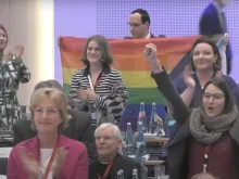Delegates at the fifth assembly of the German Synodal Way, meeting in Frankfurt, Germany, on March 11, 2023, applaud after the he passage of a text calling for changes to the German Church's approach to gender identity.