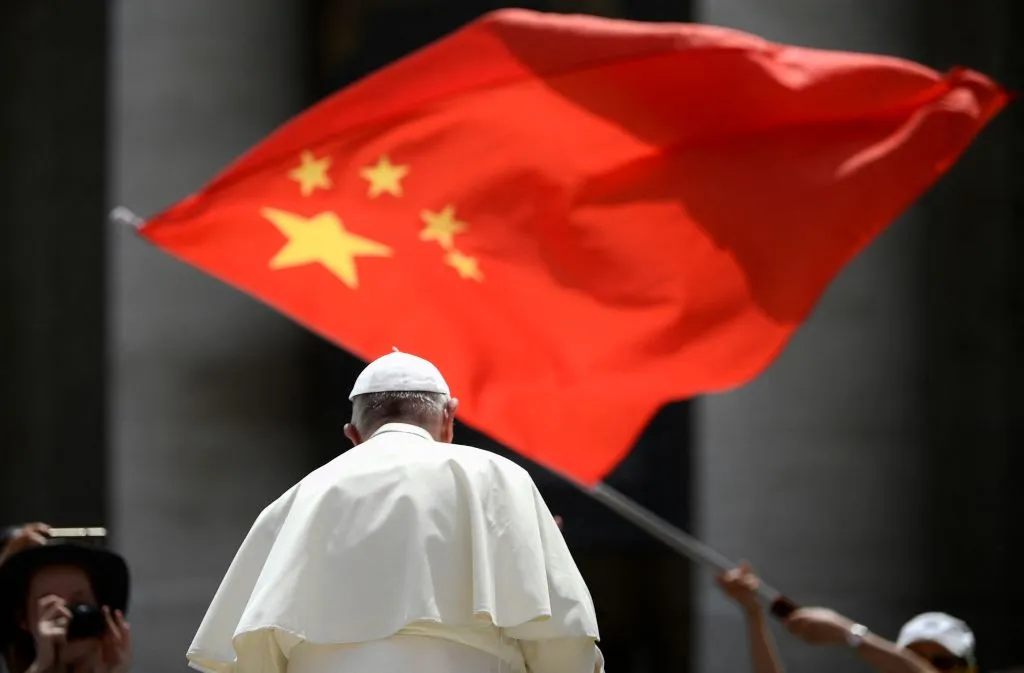 A worshiper waves the flag of China as Pope Francis leaves following the weekly general audience on June 12, 2019, at St. Peter's square in the Vatican.?w=200&h=150