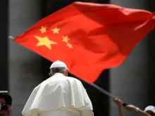 A worshiper waves the flag of China as Pope Francis leaves following the weekly general audience on June 12, 2019, at St. Peter's square in the Vatican.
