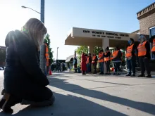 A pro-life woman kneels in prayer in front of the EMW Women's Surgical Center, an abortion clinic, in Louisville, Kentucky, on May 8, 2021.