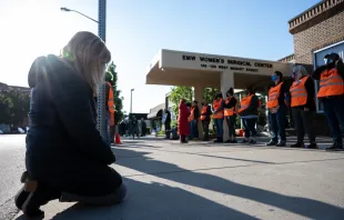 A pro-life woman kneels in prayer in front of the EMW Women's Surgical Center, an abortion clinic, in Louisville, Kentucky, on May 8, 2021. Credit: Jon Cherry/Getty Images