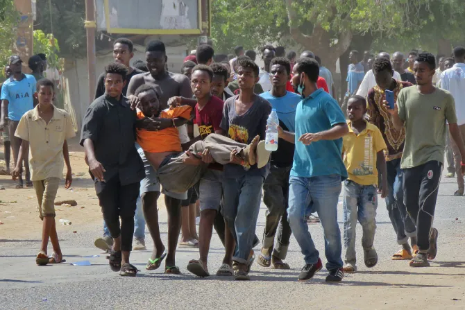Sudanese carry a man injured during clashes as part of protests against a military coup that overthrew the transition to civilian rule, on Oct. 25, 2021 in the capital Khartoum. Credit -/AFP via Getty Images