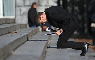 French bishops’ conference president Archbishop Éric de Moulins-Beaufort kneels in a sign of penance at Lourdes, Nov. 6, 2021. Valentine Chapuis/AFP via Getty Images.