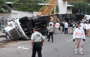 Mexican national guard officers work in the area where a trucked rolled over after a traffic accident that killed migrants from Central America, Dec. 9, 2021 in Tuxtla Gutierrez, Mexico. A truck accident leaves at least 49 people dead and dozens injured according to authorities. Most of the victims are believed to be migrants from Central American who were travelling on a truck that rolled over and crashed into a pedestrian bridge. Alfredo Pacheco/Getty Images