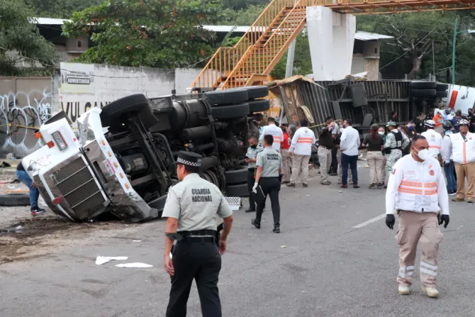 Mexican national guard officers work in the area where a trucked rolled over after a traffic accident that killed migrants from Central America, Dec. 9, 2021 in Tuxtla Gutierrez, Mexico.