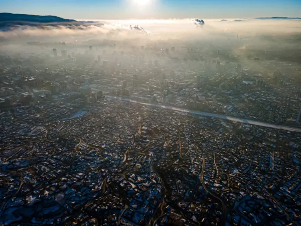 This aerial picture taken on Jan. 16, 2022, shows smoke hanging over houses on a polluted day in Ulaanbaatar, the capital of Mongolia. Credit: Byambasuren Byamba-Ochir/AFP via Getty Images