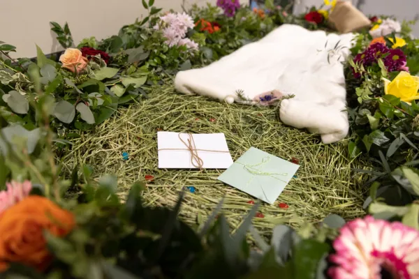 A demonstration "vessel" for the deceased, which has been decorated with flowers and compostable mementos by Return Home on top of a bed of straw, is pictured during a tour of the funeral home that specializes in human composting in Auburn, Washington, on March 14, 2022. Human composting is now legal in Washington, California, and a handful of other states. Photo by JASON REDMOND/AFP via Getty Images