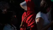 Pamela Smith dressed as characters of "The Handmaids Tale" walks with a noose around her neck as she joins pro-choice protesters gather in large numbers in front of the federal building to defend abortion rights in San Francisco on May 3, 2022.