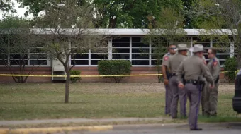 State troopers stand outside of Robb Elementary School in Uvalde, Texas, on May 24, 2022. - An 18-year-old gunman killed 14 children and a teacher at an elementary school in Texas on Tuesday, according to the state's governor, in the nation's deadliest school shooting in years.
