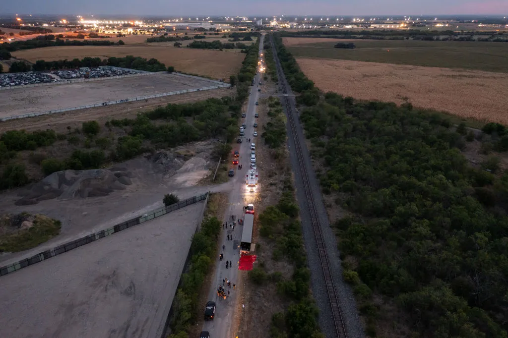 In this aerial view, members of law enforcement investigate a tractor trailer on June 27, 2022 in San Antonio, Texas. According to reports, at least 46 people, who are believed migrant workers from Mexico, were found dead in an abandoned tractor trailer. Over a dozen victims were found alive, suffering from heat stroke and taken to local hospitals.?w=200&h=150