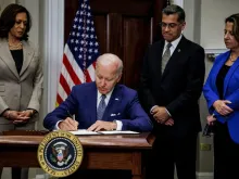 US President Joe Biden, with (L-R) Vice President Kamala Harris, Health and Human Services Secretary Xavier Becerra and Deputy Attorney General Lisa Monaco, signs an executive order protecting access to reproductive health care services, in the White House in Washington, DC, July 8, 2022.