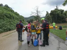 A stranded family is rescued from the flood waters of the north fork of the Kentucky River in Jackson, Ky., on July 28, 2022. Catholic Charities of Lexington is collaborating with other Christian churches as well as Catholic Charities USA to provide aid to those affected.