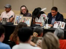 Mark Arcand (R), brother of James Smith Cree Nation stabbing victim Bonnie Burns, and Brian (2nd R), husband of Bonnie, pause behind pictures of Bonnie during a news conference in Saskatoon, Saskatchewan, Canada, Sept. 7, 2022. - One of two brothers who were the target of a massive manhunt in Canada after allegedly carrying out a stabbing spree that left 10 dead and 18 wounded has been found dead, police said on September 5. The killings in the remote James Smith Cree Nation Indigenous community and the town of Weldon in Saskatchewan province in western Canada are among the deadliest incidents of mass violence ever to hit the nation.