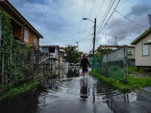 A man walks down a flooded street in the Juana Matos neighborhood of Catano, Puerto Rico, on Sept.19, 2022, after the passage of Hurricane Fiona. Hurricane Fiona smashed into Puerto Rico, knocking out the U.S. island territory's power while dumping torrential rain and wreaking catastrophic damage before making landfall in the Dominican Republic on Sept. 19, 2022.