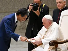 Pope Francis speaks with Punit Renjen, an Indian-American businessman and CEO of the multinational professional services firm Deloitte, during an audience to the participants of the Deloitte Global meeting on Sept. 22, 2022, at Paul VI Hall in the Vatican.